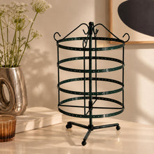 Charger l'image dans la galerie, Porte-boucles d'oreilles rotatif noir vide sur une commode beige, près d'un vase argenté
